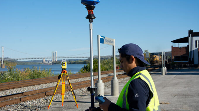 Surveyor using Carlson GNSS receiver and total station at a job site in Maysville, Kentucky